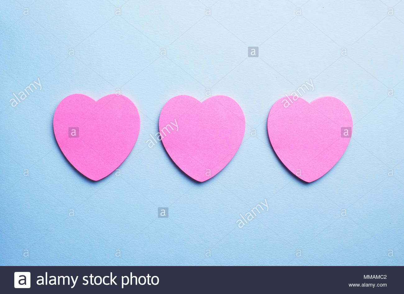 Pink Heart Shaped Sticky Notes Organized In A Row Over Blue