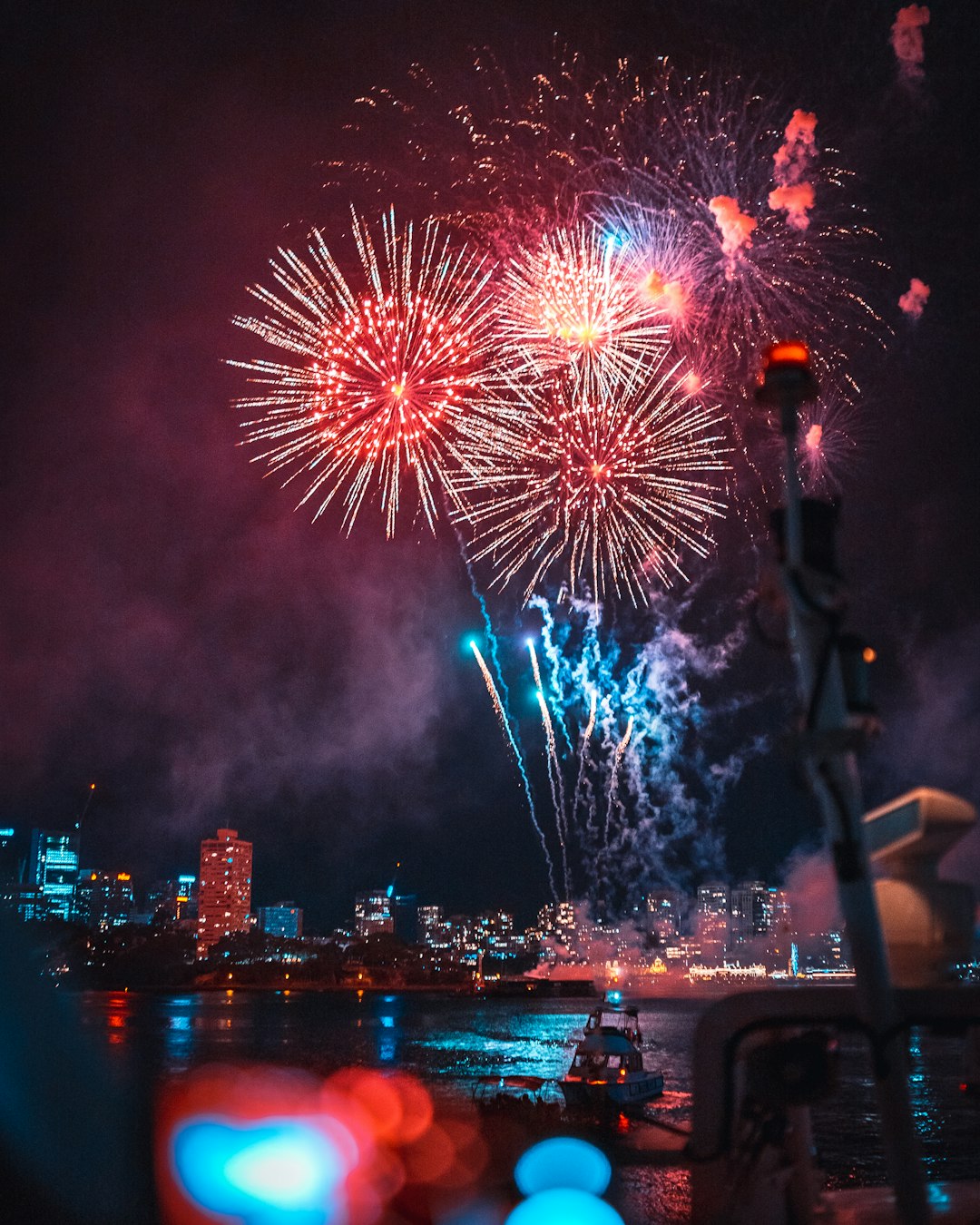 Fireworks explode over a city skyline during New Year's Eve celebrations