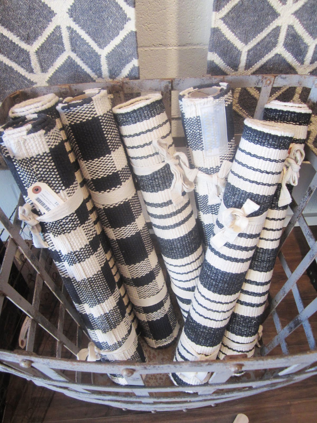 Lots of flat weave cotton rugs in navy and white plaids and stripes