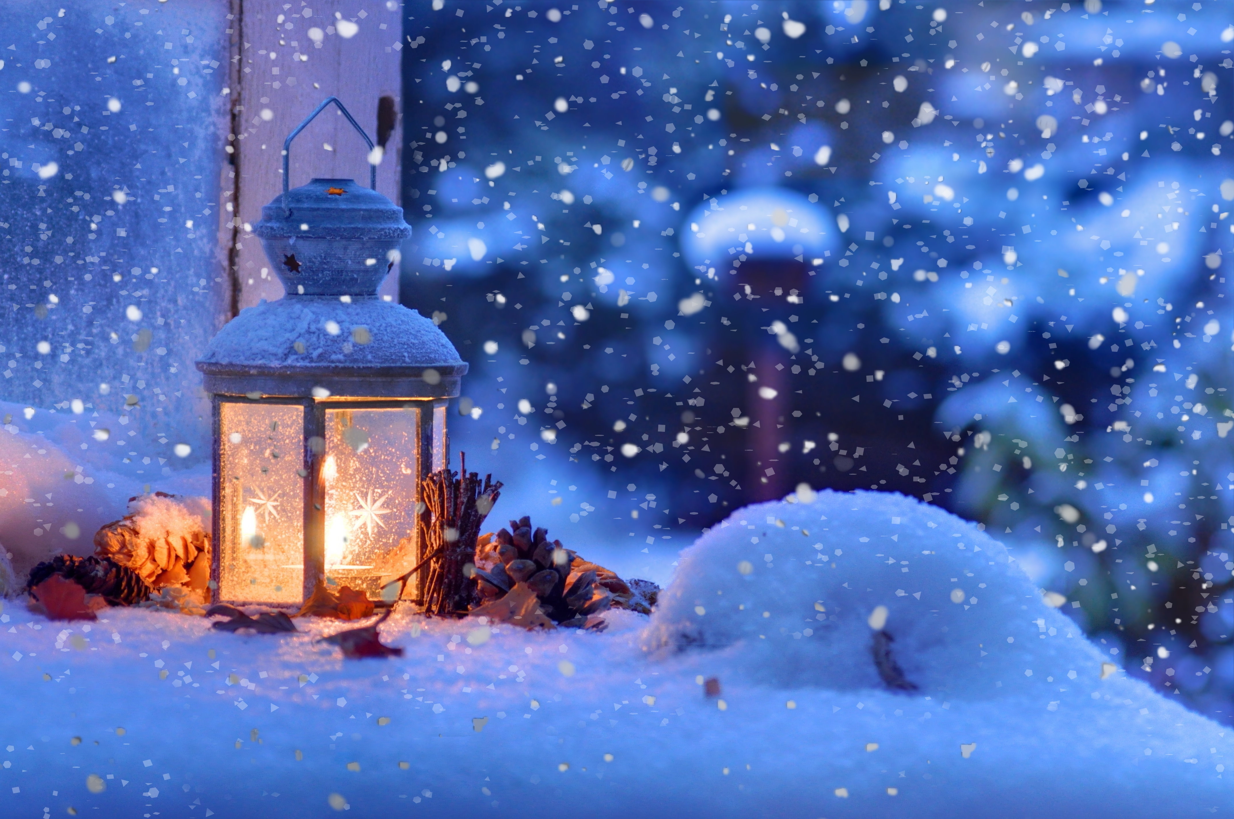 A frosted lantern glows warmly amidst a snowy winter scene, creating a cozy and festive atmosphere