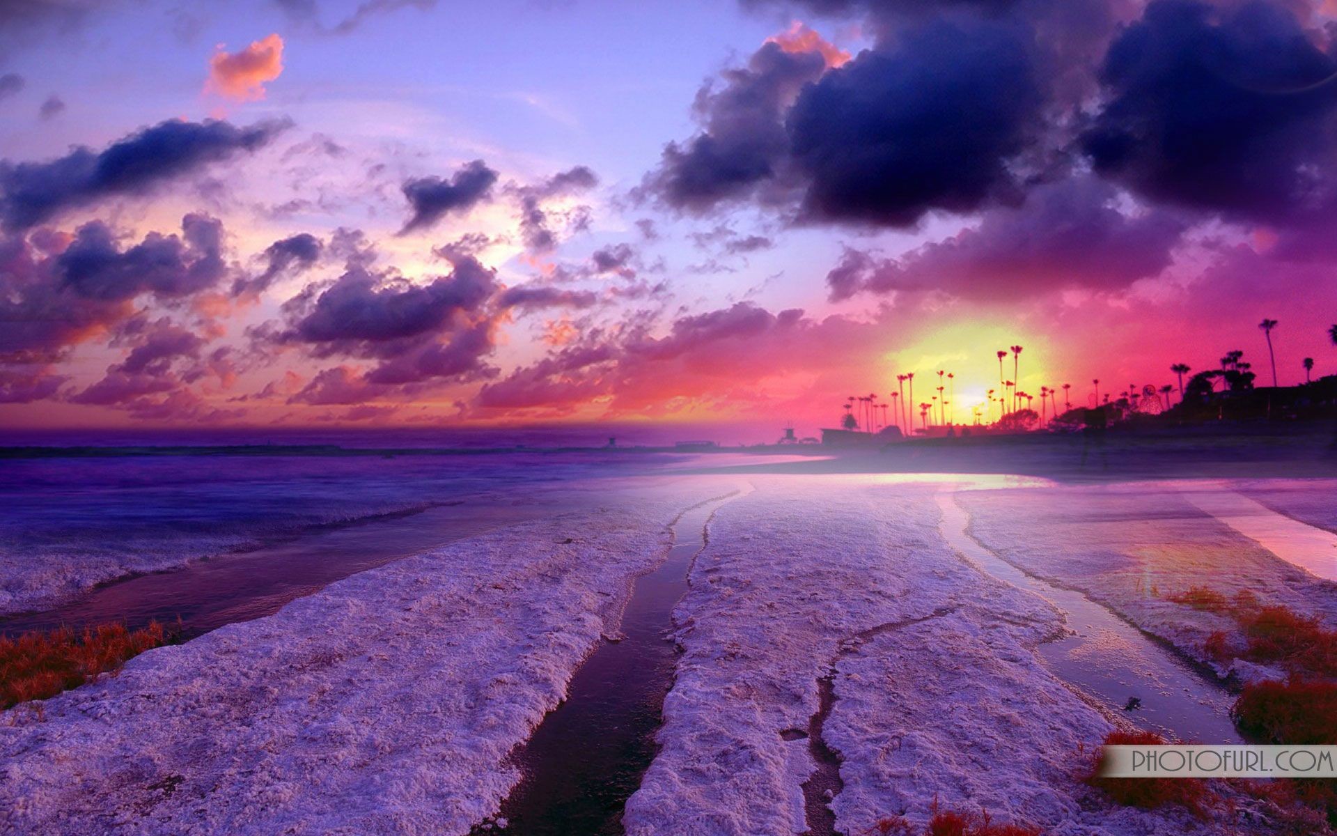 A breathtaking sunset over a tranquil beach, with vibrant purple and pink hues painting the sky. The foreground features unique textured sand patterns, adding to the serene beauty of the scene