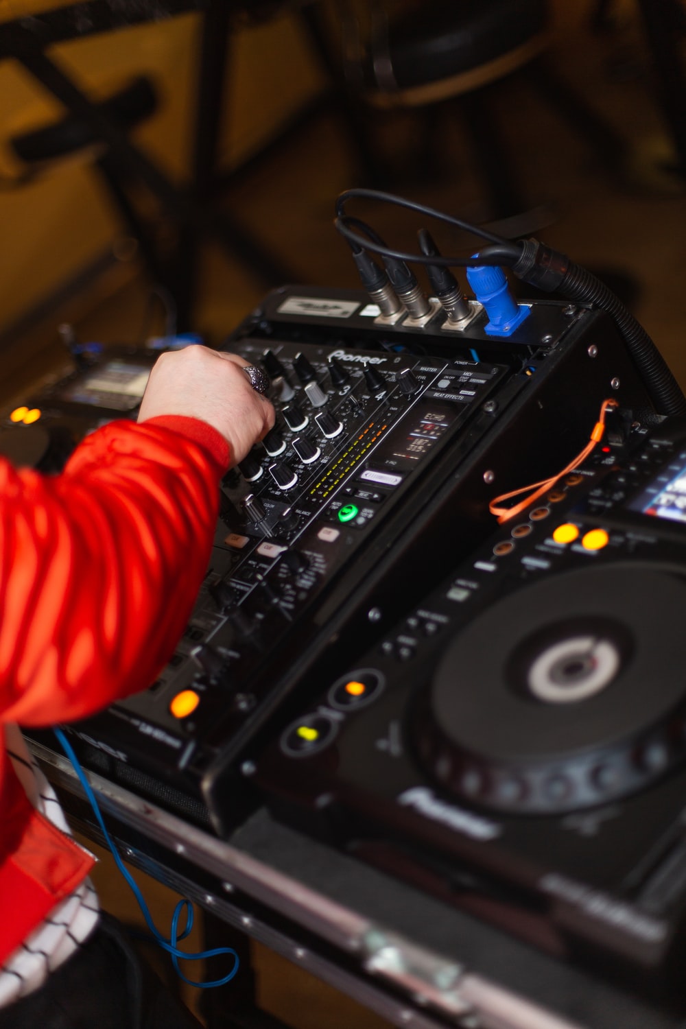 Person In Red Long Sleeve Shirt Playing Dj Controller Photo