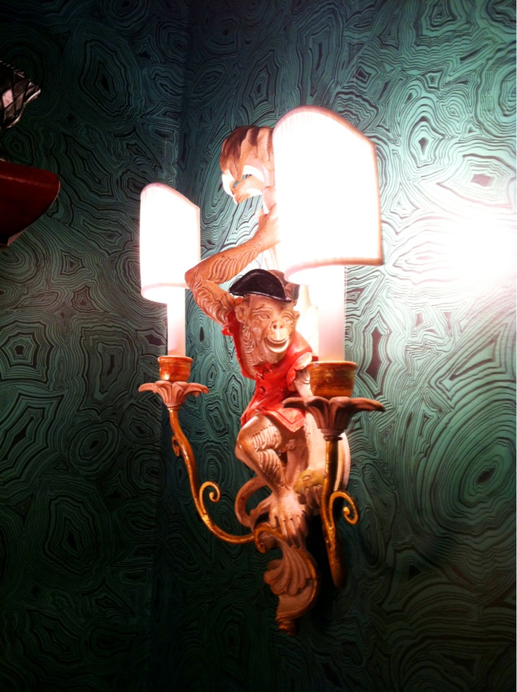 Whimsical Monkey Sconce In A Room With Malachite Inspired Wallpaper