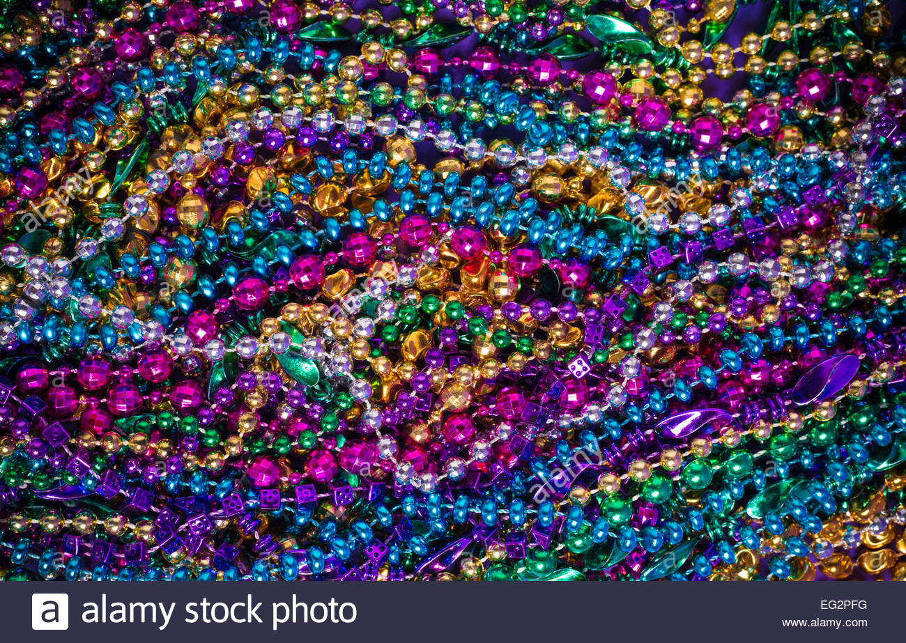 Background Of Large Amount Mardi Gras Bead On A Purple