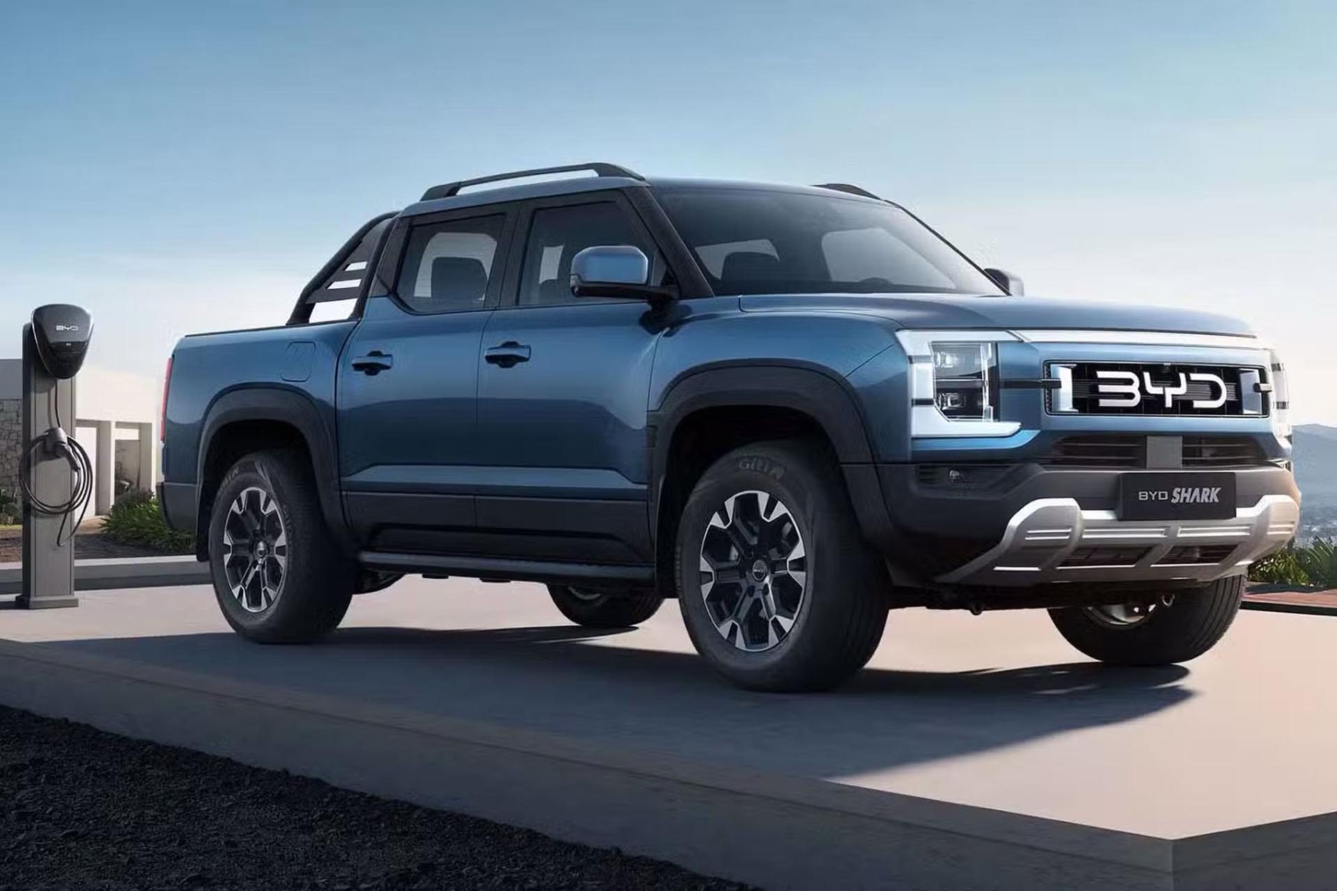 A blue BYD Shark pickup truck charging at a charging station