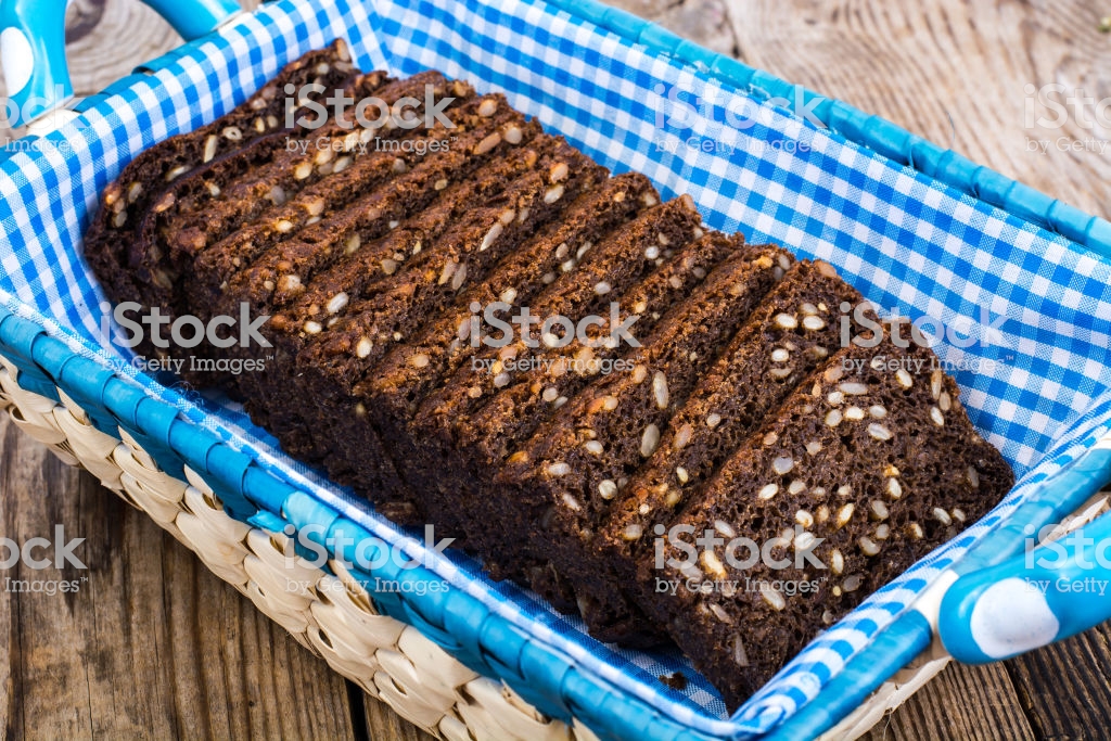 Black Rye Bread With Cereal Seeds On White Background Stock Photo