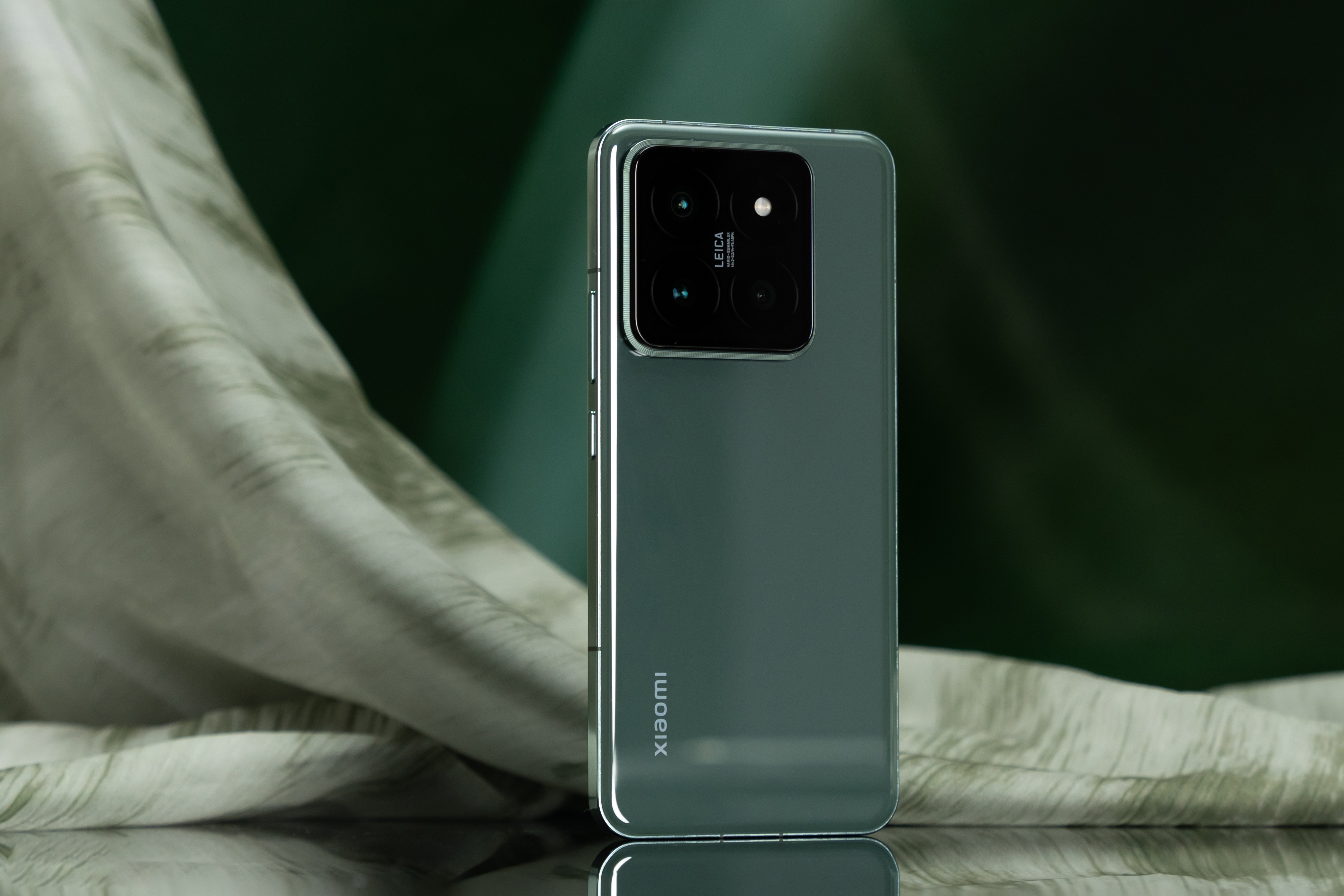 Xiaomi 14 Pro in a stylish light green color, showcasing its sleek design and Leica-branded camera module