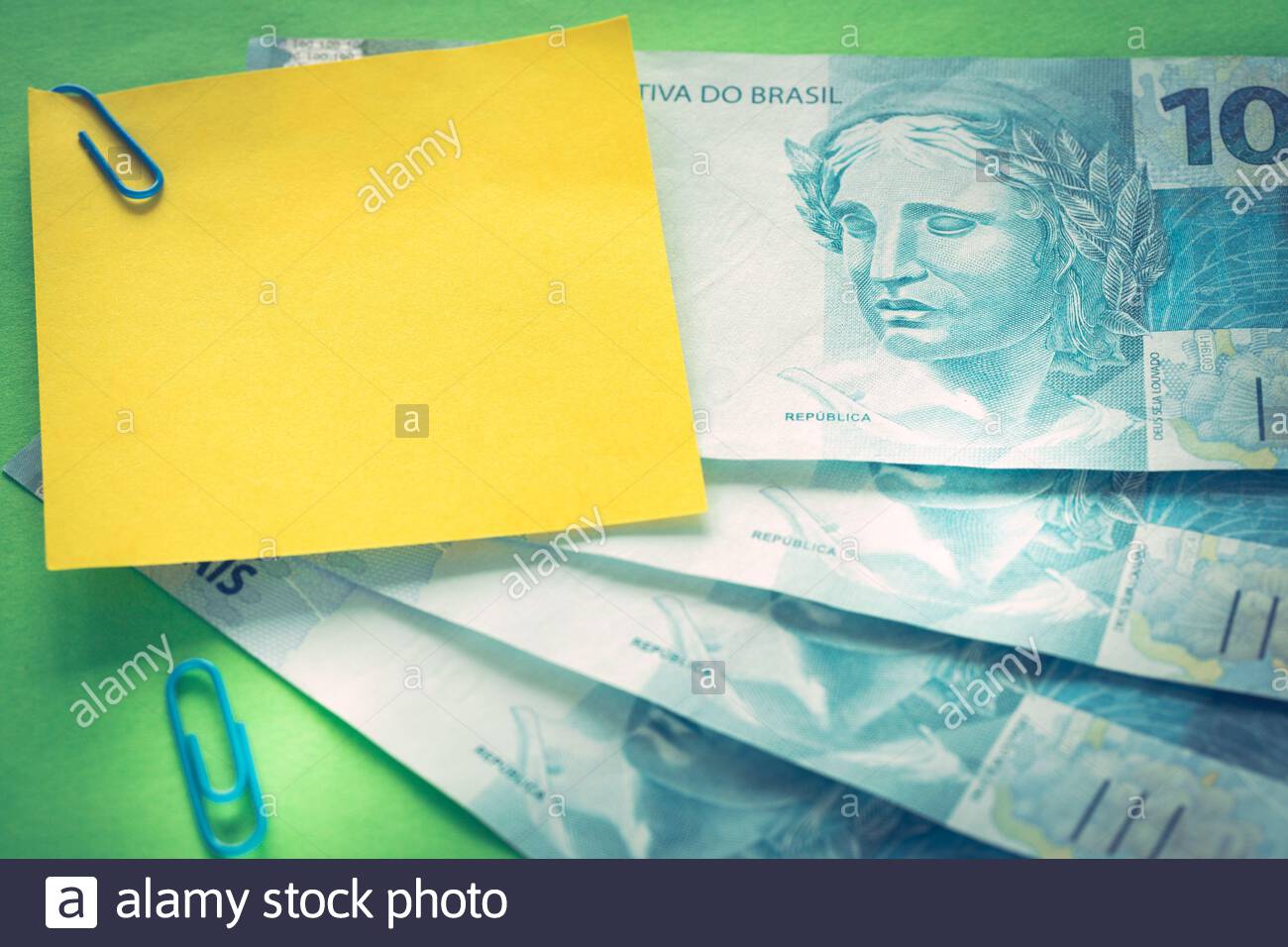 Brazilian Money Reais Banknotes On Green Background With