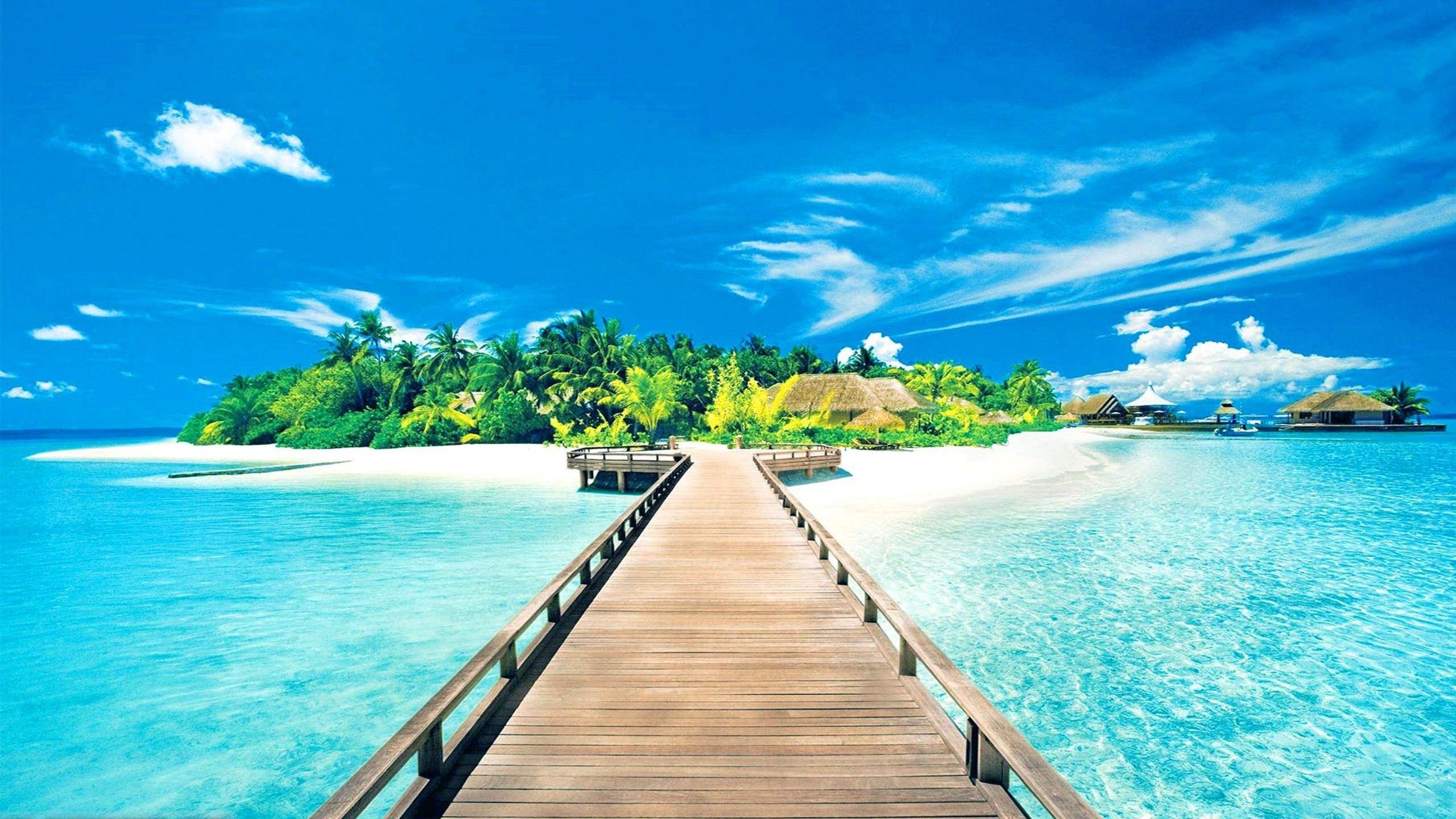 Tropical island paradise with wooden pier and overwater bungalows in the Maldives