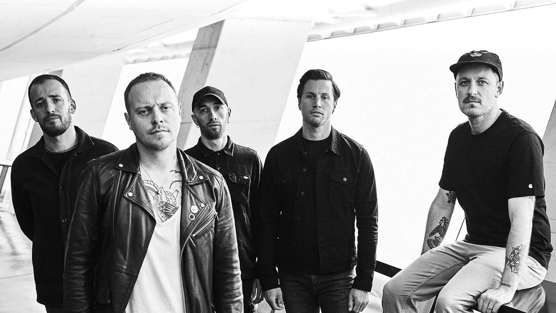 Black and white photo of a band, possibly a rock or alternative group, posing together