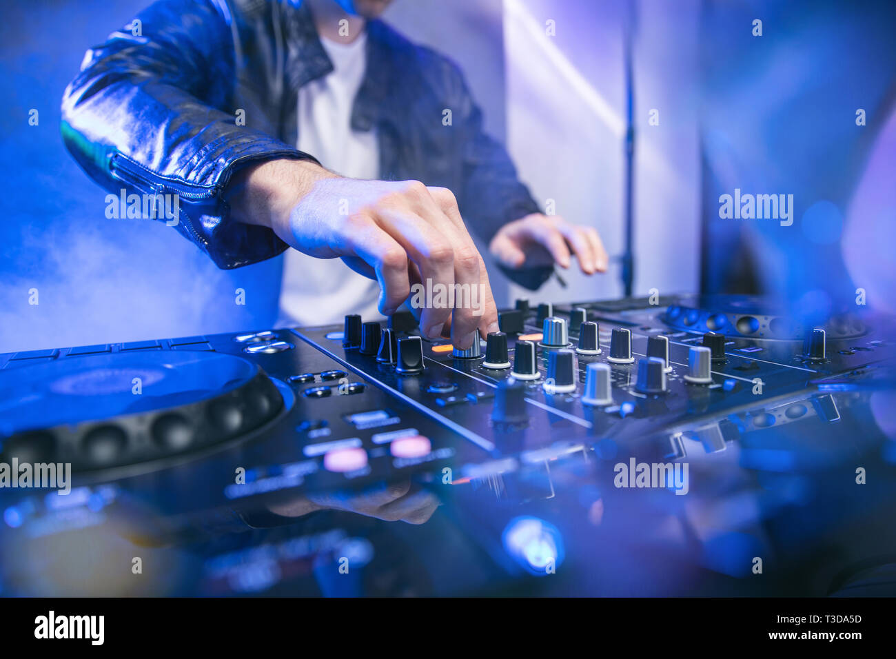 Dj Mixing At Party Festival With Blue Lights And Smoke In