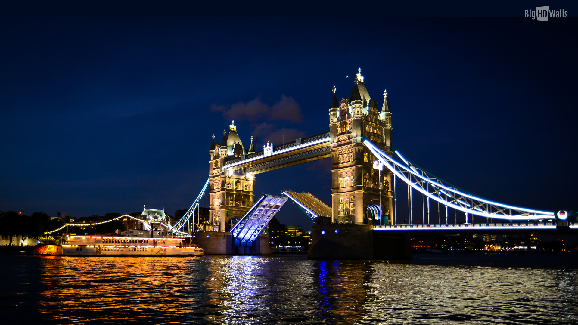 He Tower Bridge All Lit Up At Night And Opened For A Ferry To Pass
