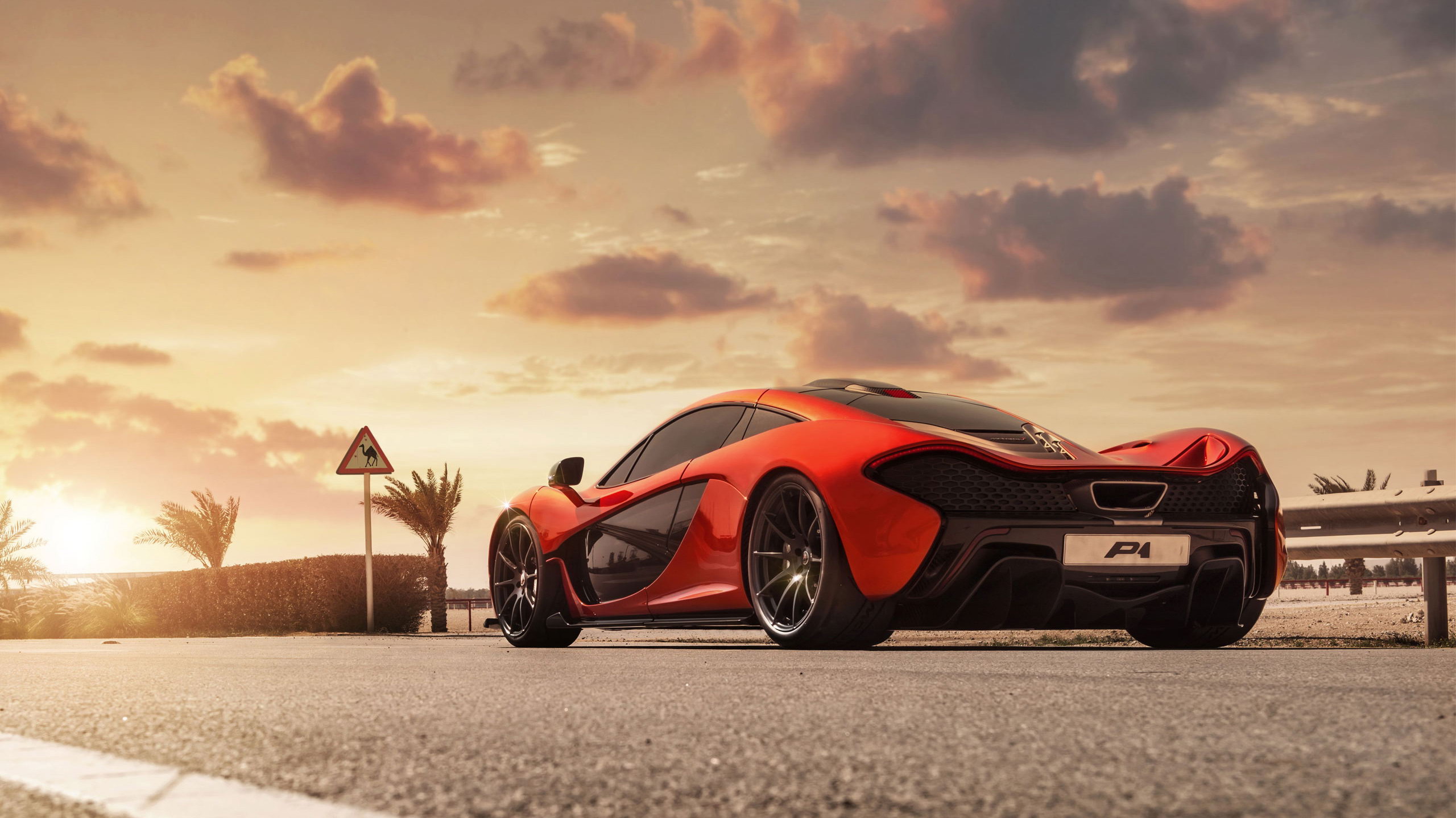 Red McLaren P1 Supercar Parked on Road at Sunset