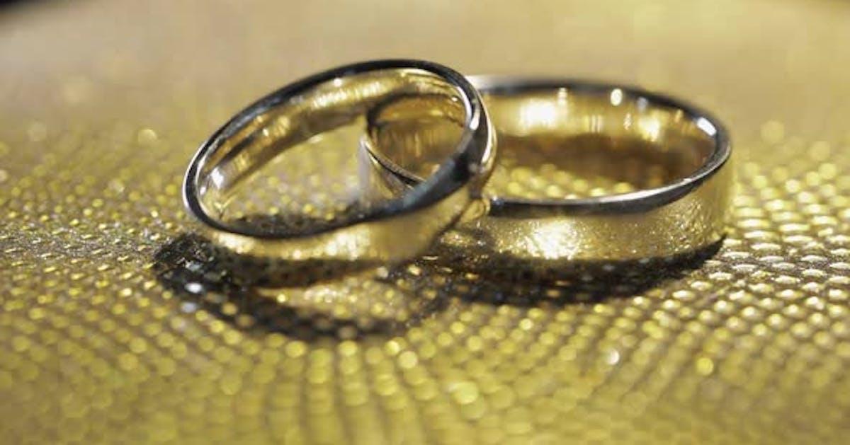 Wedding Rings Lying Rotate Spinning On Shiny Golden Shining