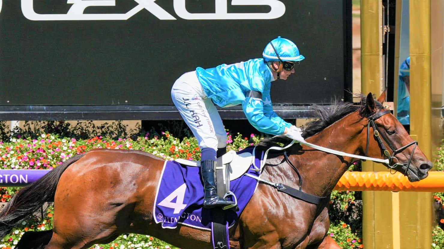 Champion Jockey Jamie Kah Smiling At The Racecourse Wallpaper