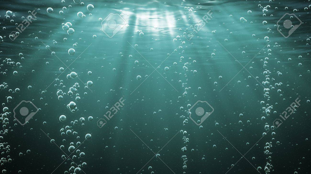 Dark Green Ocean Waves From Underwater With Bubbles Light Rays