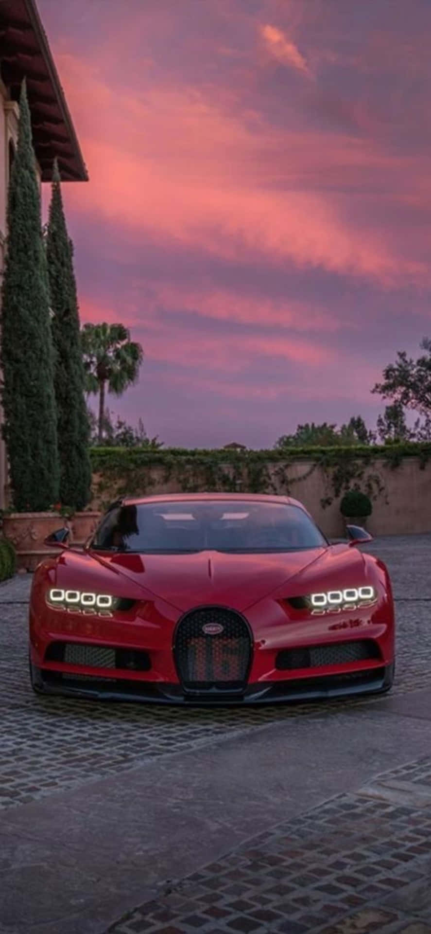 An iPhone Xs With A Luxurious Bugatti Background Wallpaper