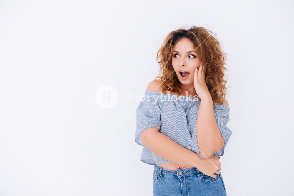 Surprised Woman In Singlet With Hand On Cheek And Open Mouth