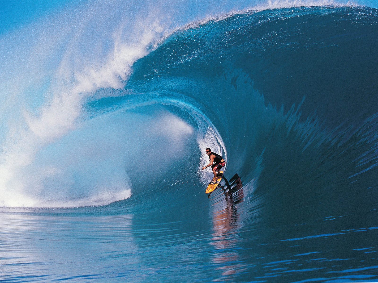 A surfer riding a powerful ocean wave, showcasing the thrill and skill of surfing